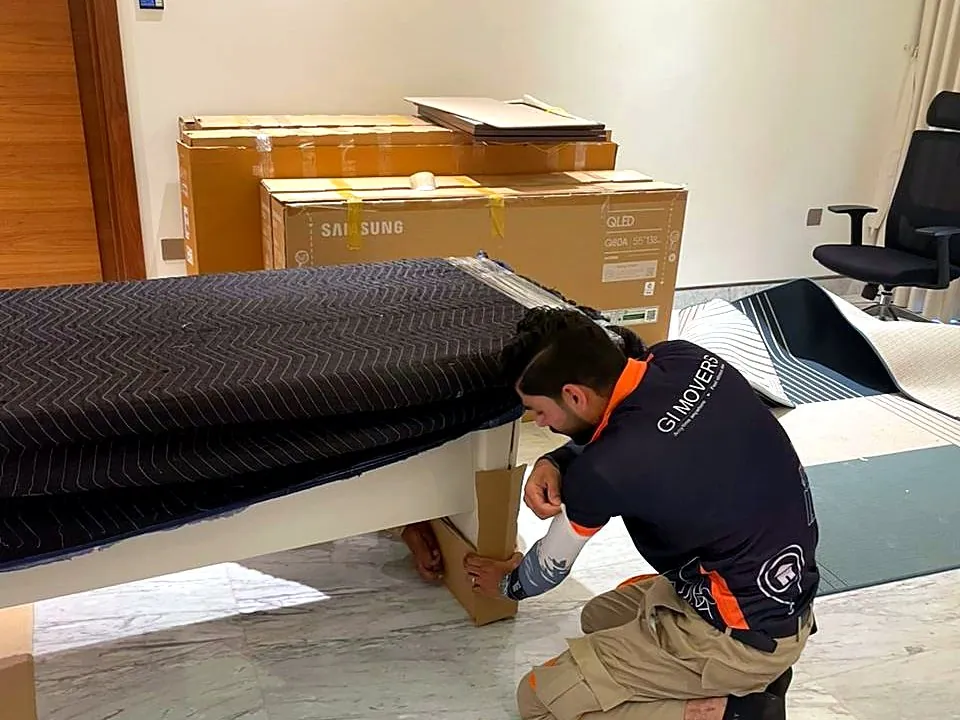 GI Movers crew protecting an executive desk during an office move