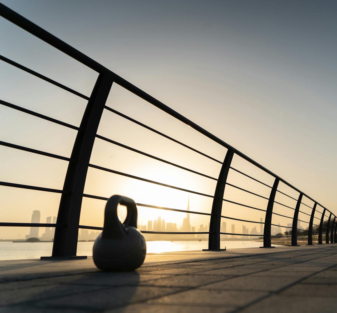 Kettlebell on Bridge near Sea on Sunset