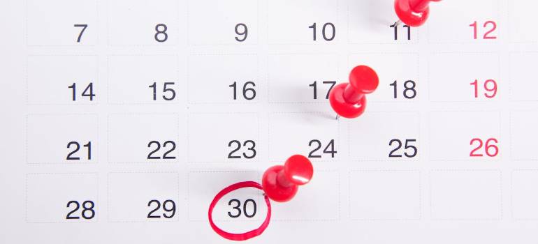 calendar with pins on moving date questions to ask your Dubai moving company