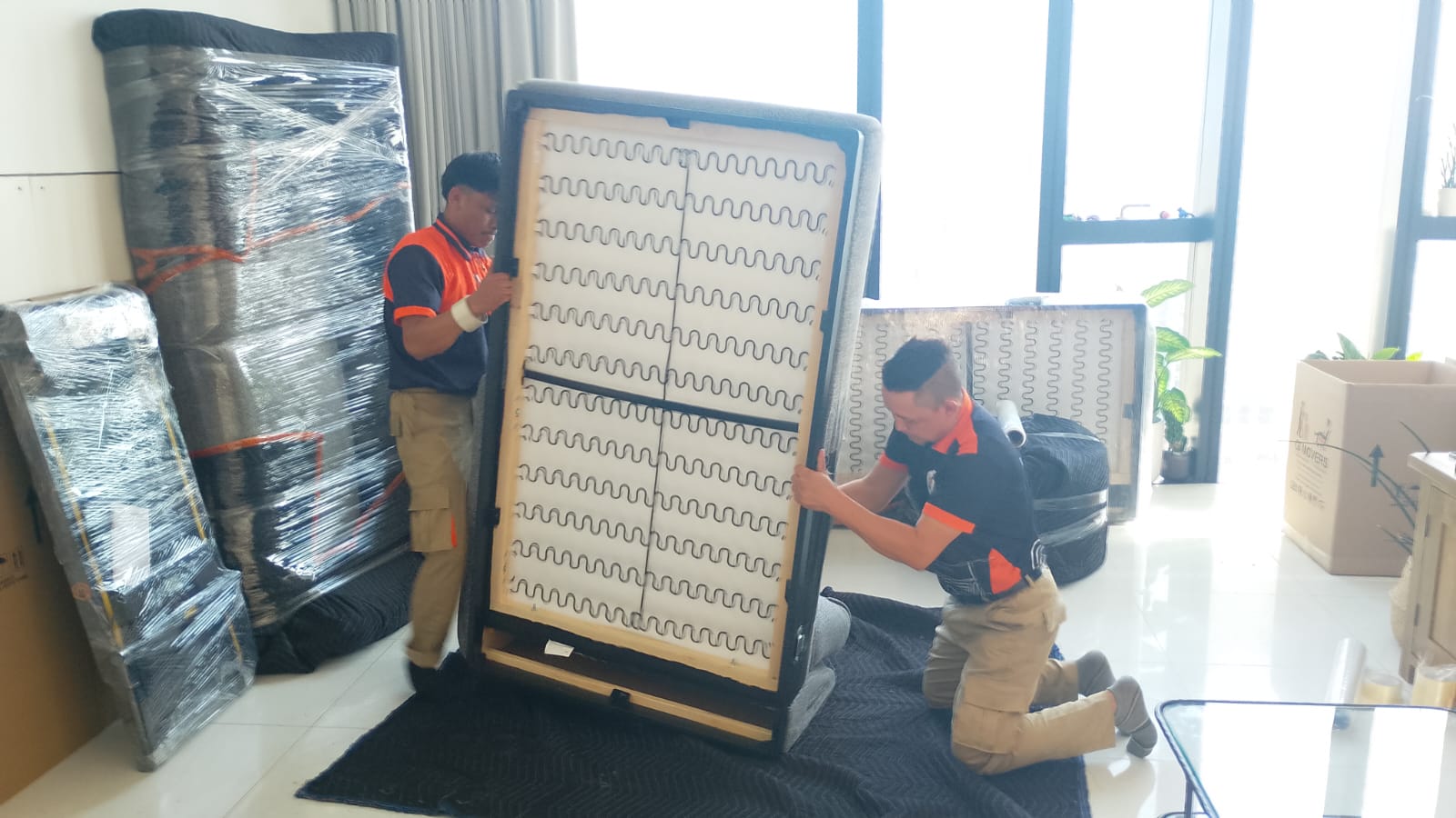 Movers loading furniture for a villa move in Zayed City