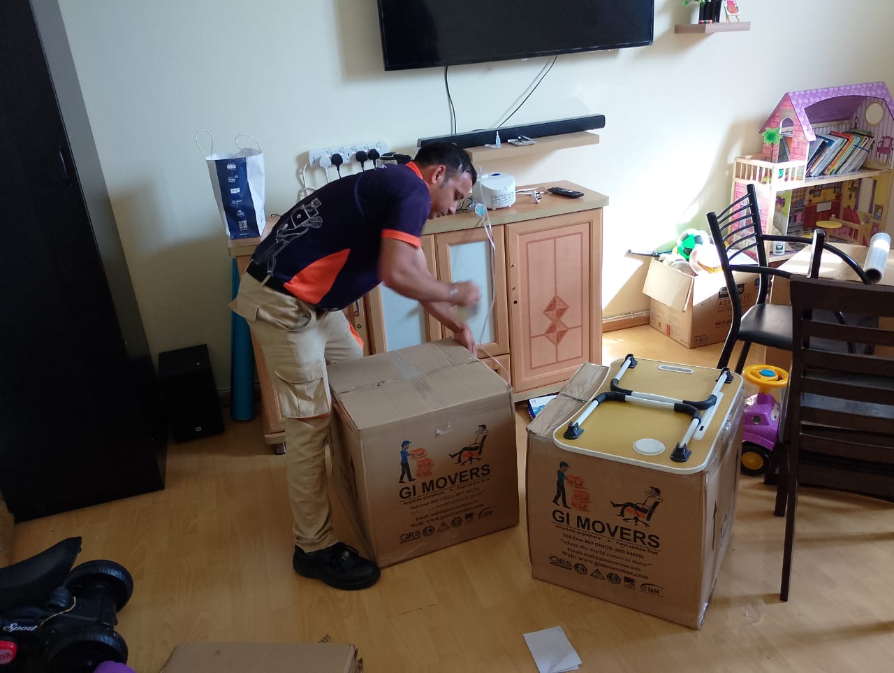 Professional movers packing furniture in Dubai Hills
