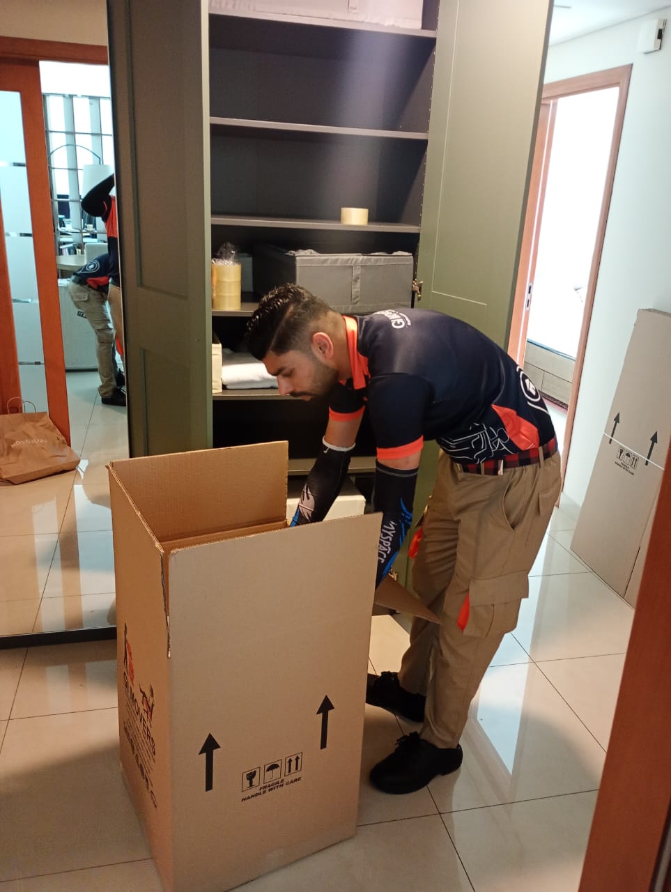 Movers packing furniture for a home move in JVC Dubai