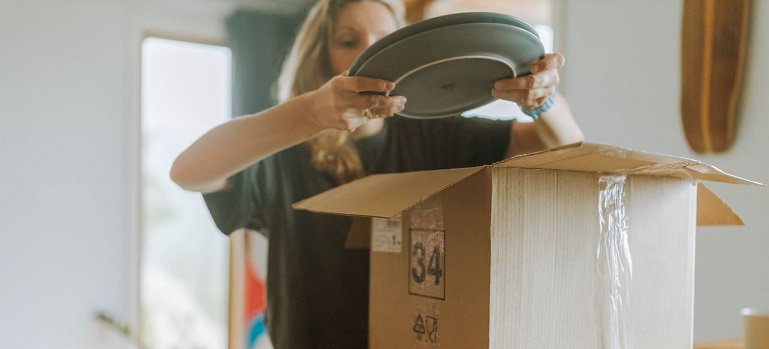 a woman trying to unpack after the move to the UAE