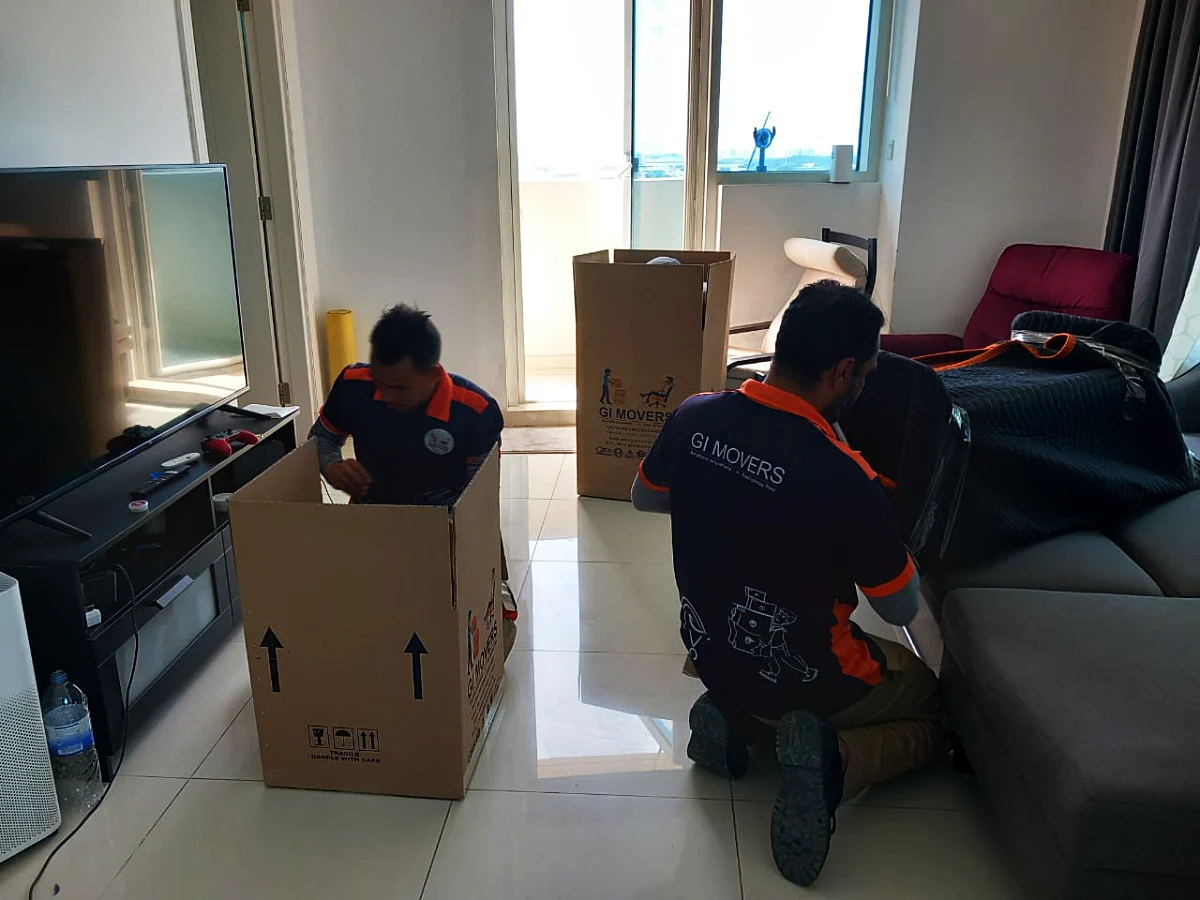 GI Movers crew packing household items into boxes for storage in Dubai