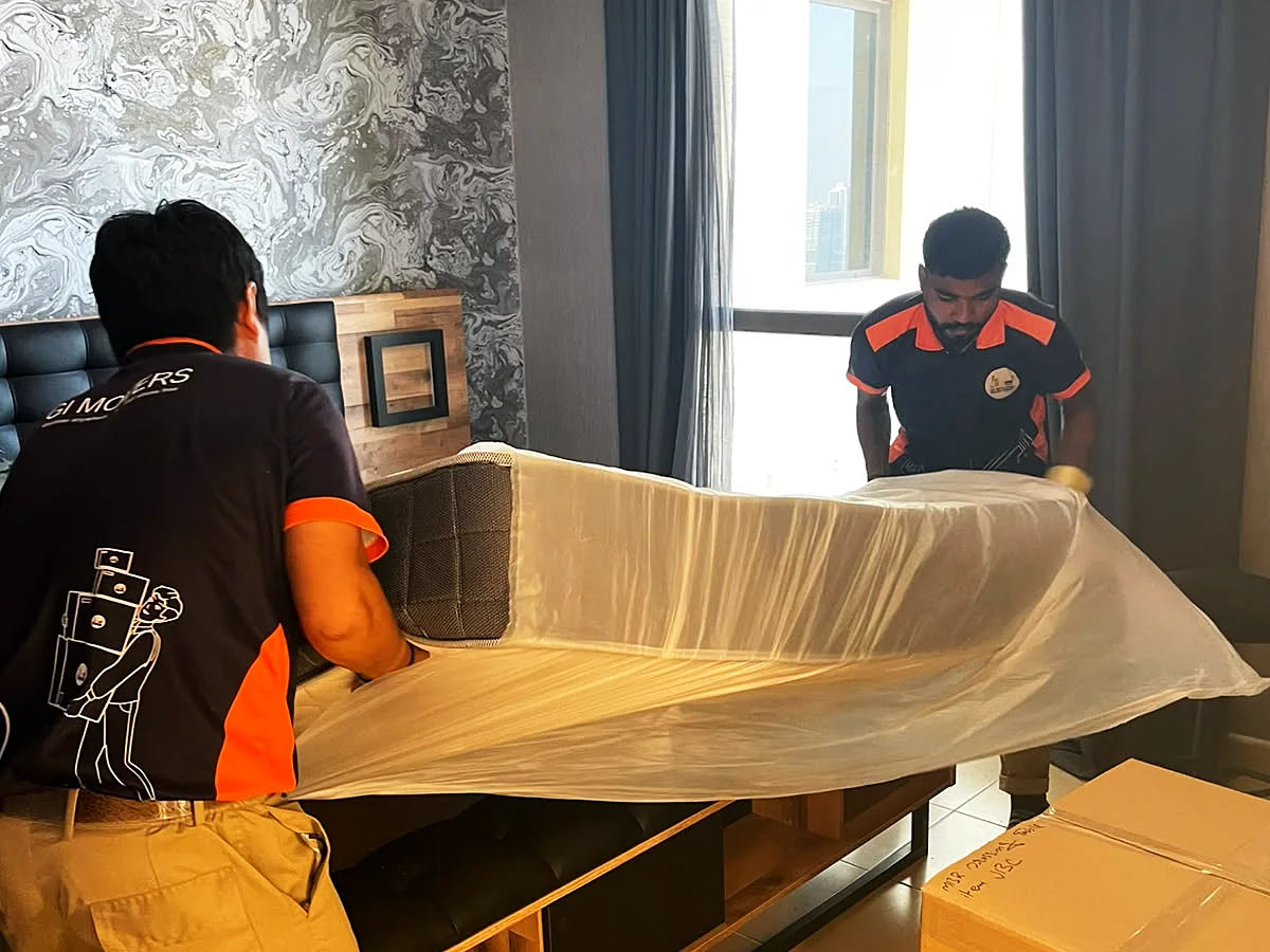 GI Movers crew wrapping furniture for an international move from Dubai