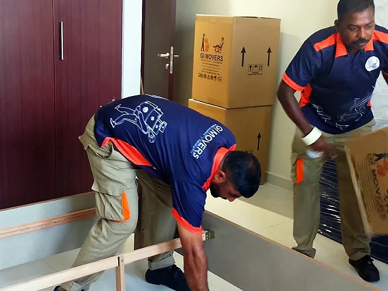 GI Movers crew packing a bedroom during a house move in Abu Dhabi