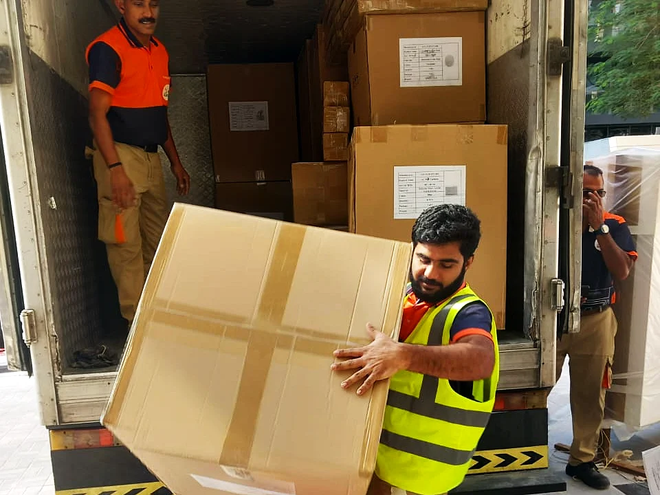 GI Movers crew loading packed boxes onto the truck for storage in Abu Dhabi