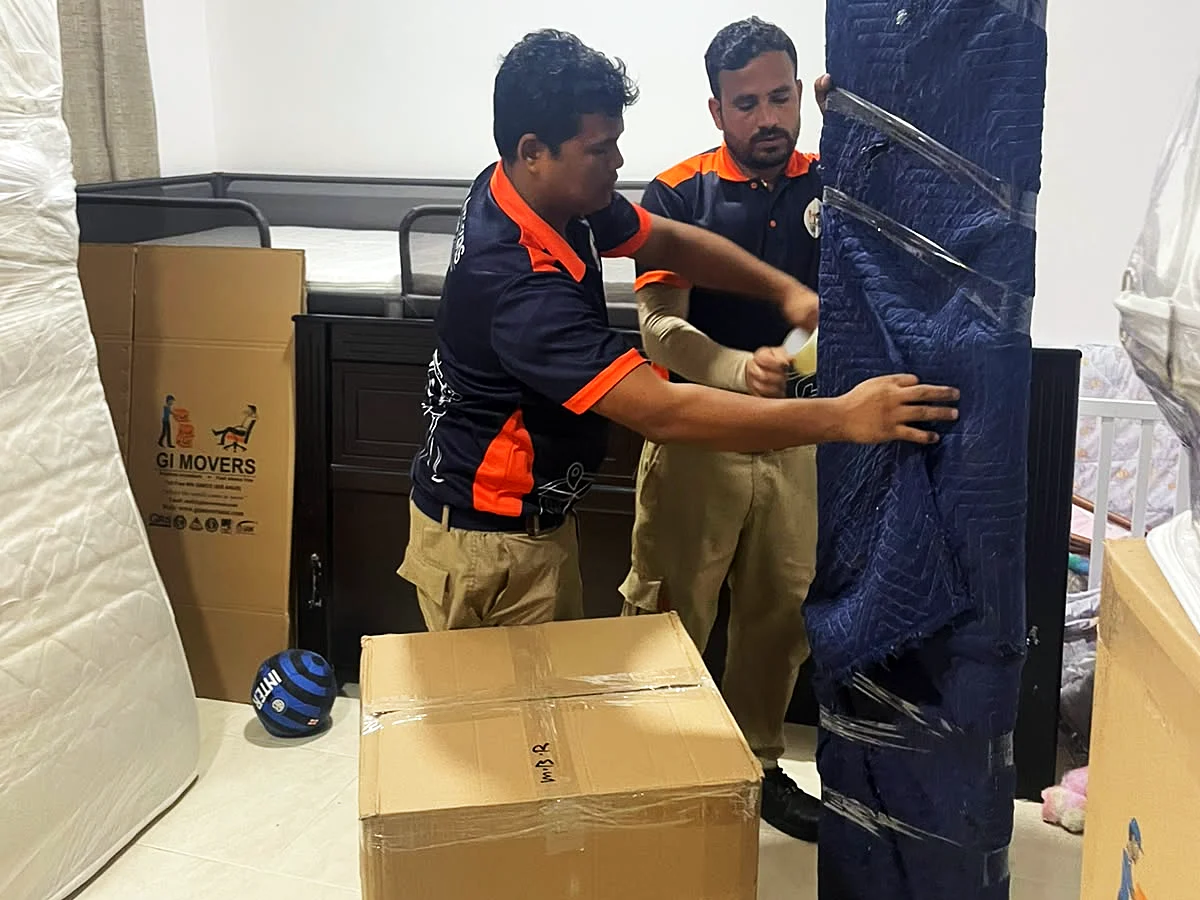GI Movers crew wrapping furniture for storage in Abu Dhabi